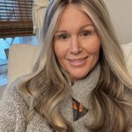 Portait of smiling woman wearing a custom dimensional blonde wig